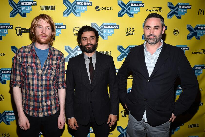 Actor Domhnall Gleeson, left, actor Oscar Isaac and director Alex Garland arrive at the premiere of "Ex Machina" during the 2015 South by Southwest film festival.