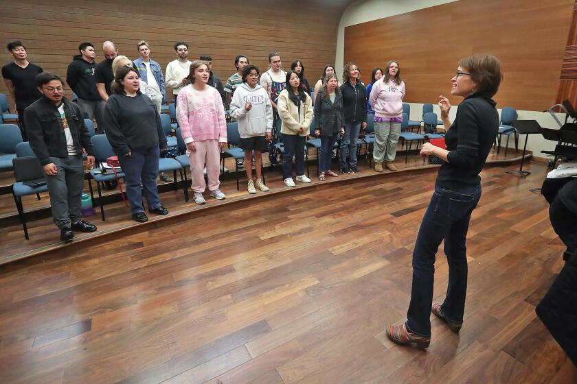OCC conductor Eliza Rubenstein leads Orange Coast College's chamber singers, some who will become one of the first choruses in the world to present a brand-new Spanish-language version of Handel's Messiah. The new edition will be called El Mesias