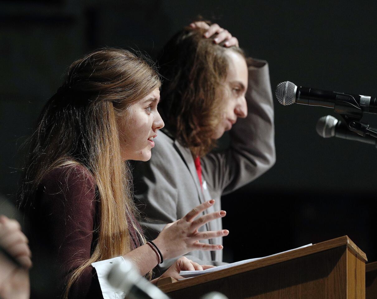 As Phoebe Kellogg completes her statement about the death penalty, her opponent Collin Moyseyev pulls his hair back in a first ever BHS political debate in the Wolfson Auditorium at Burbank High School on Tuesday, October 9, 2018.