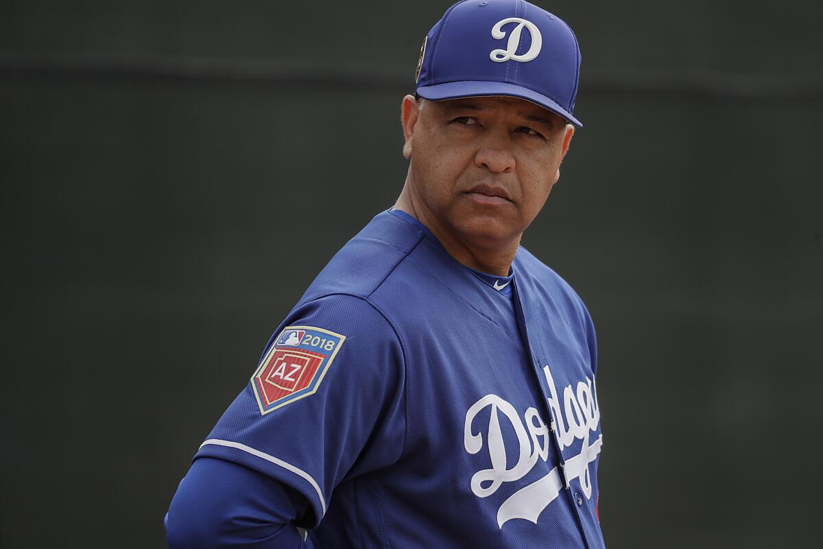 Dodgers manager Dave Roberts watches over a spring training workout at the Camelback Ranch complex in Phoenix.