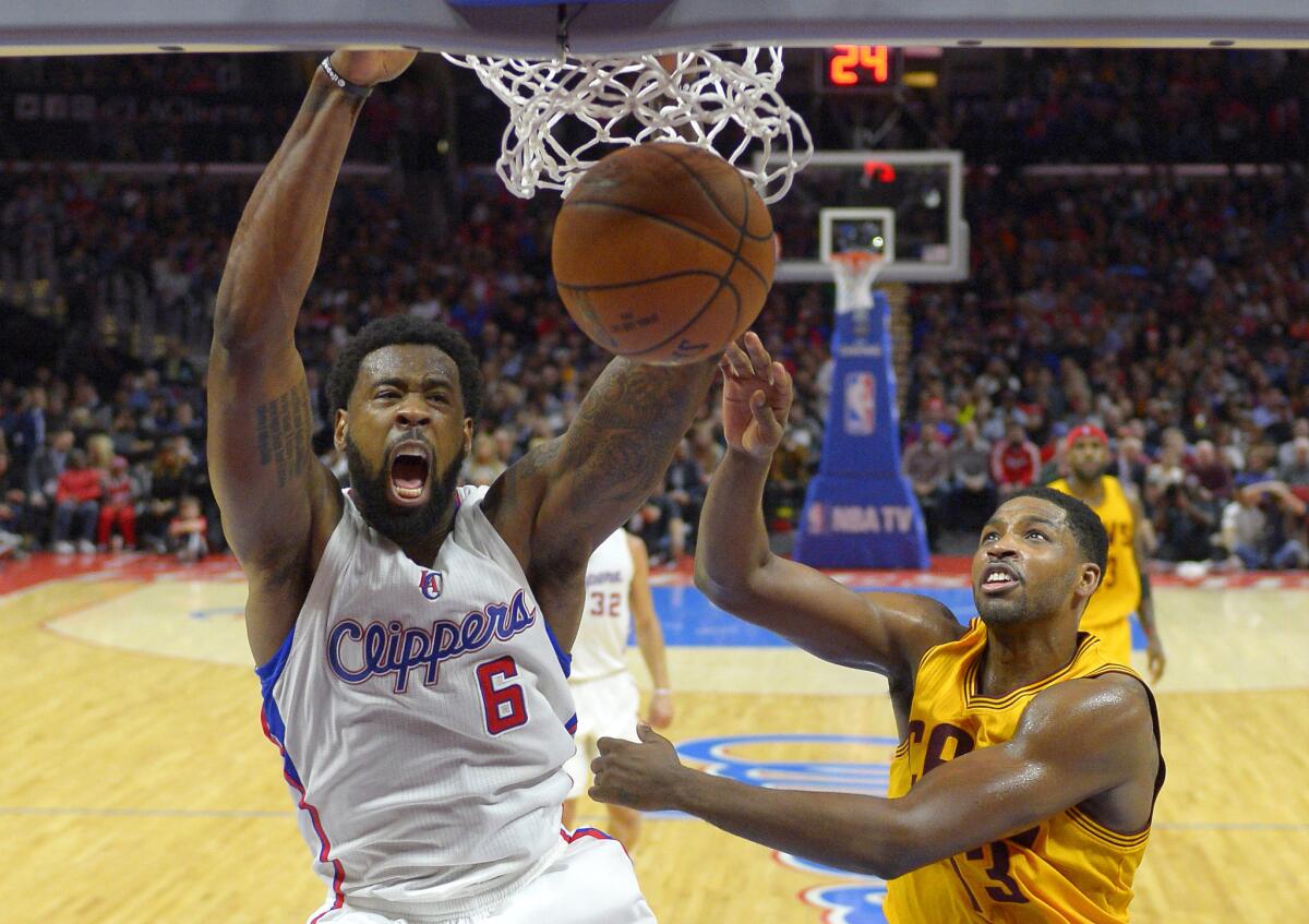 Clippers center DeAndre Jordan slams home a jam against Cavaliers center Tristan Thompson last week.