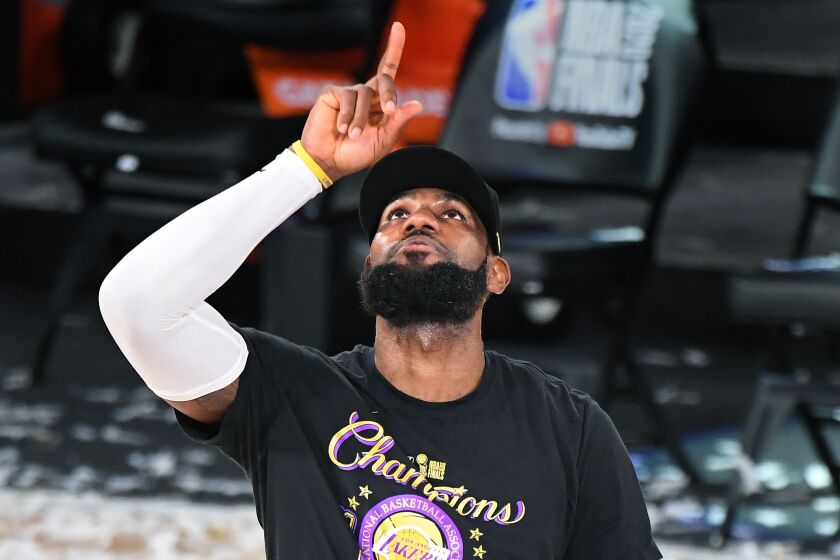 Lakers' LeBron James points to the sky after winning the NBA Championship