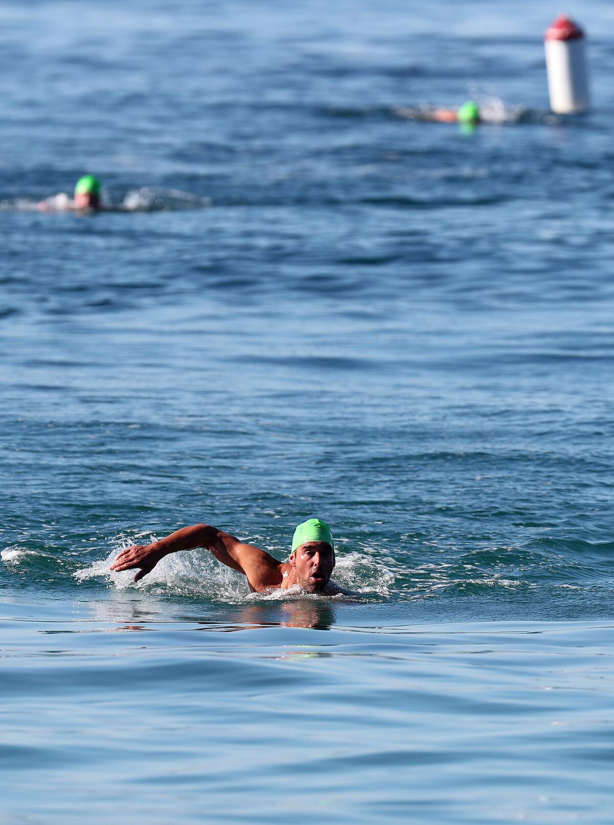 A participant swims back to the beach during Laguna Beach ocean lifeguard tryouts at Main Beach on Saturday.