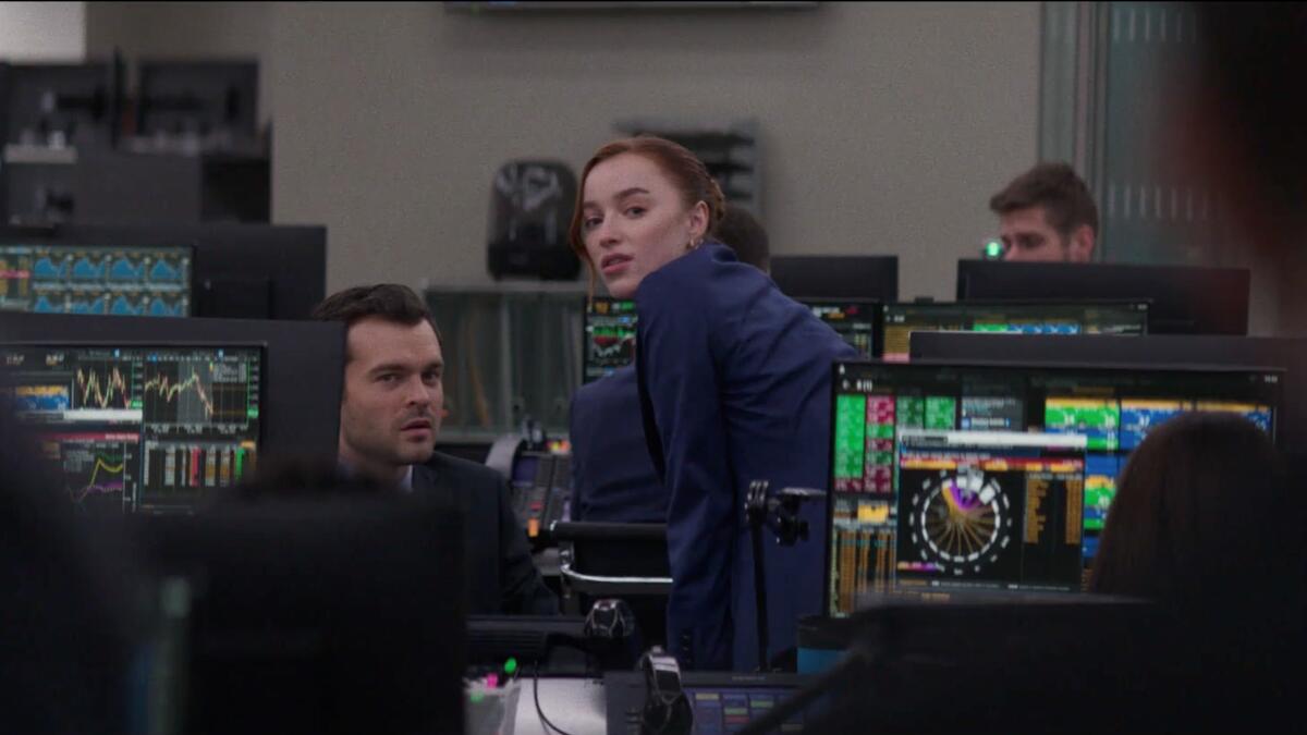 A man and a woman on a trading floor