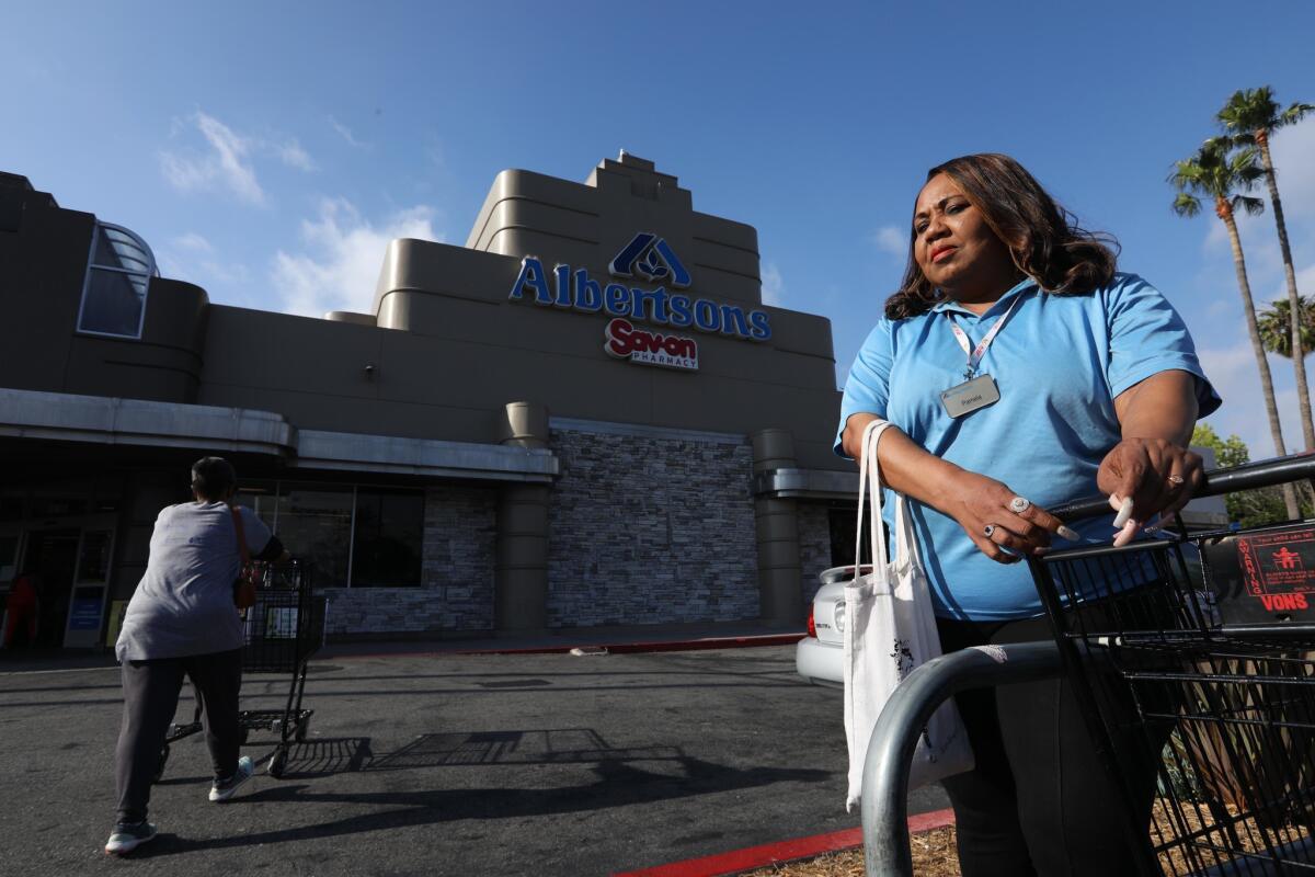 Albertsons cashier Pamela Hill, shown Thursday outside her store on Crenshaw Boulevard in Los Angeles, says she's ready to strike if supermarket and union leaders can't reach a new contract. Genaro Molina / Los Angeles Times