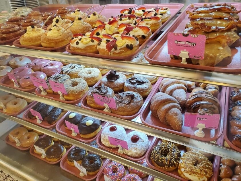 Barrio Donas also features quintessentially American doughnuts, like Bacon Piggy (upper right).