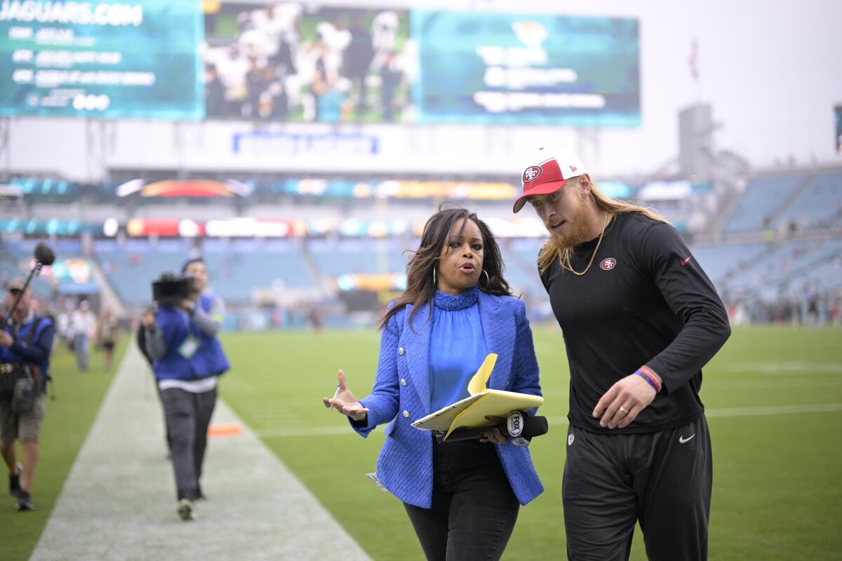 Fox Sports sideline reporter Pam Oliver talks with San Francisco 49ers tight end George Kittle on the field 