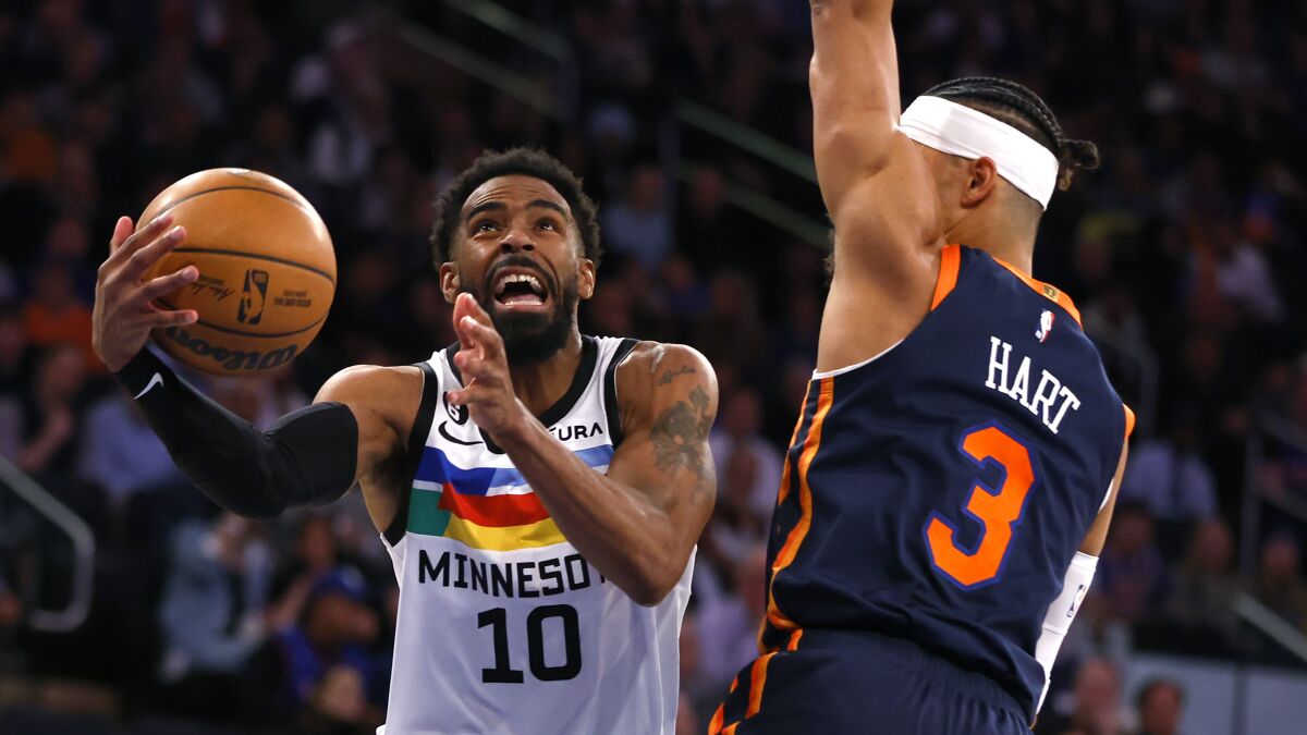 Minnesota Timberwolves guard Mike Conley (10) drives to the basket against New York Knicks guard Josh Hart (3) during the first half of an NBA basketball game, Monday, March 20, 2023, in New York. (AP Photo/Noah K. Murray)