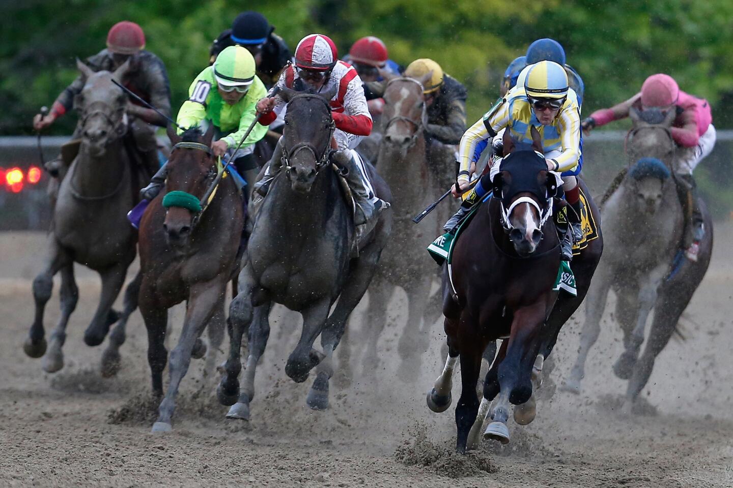 Classic Empire, with Julien Leparoux aboard, leads the field around the finalturn during the 142nd running of the Preakness Stakes.