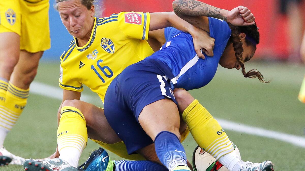 Sweden defender Lina Nilsson (16) hauls down U.S. forward Sydney Leroux in the second half of their Group D game at the Women's World Cup on Friday.
