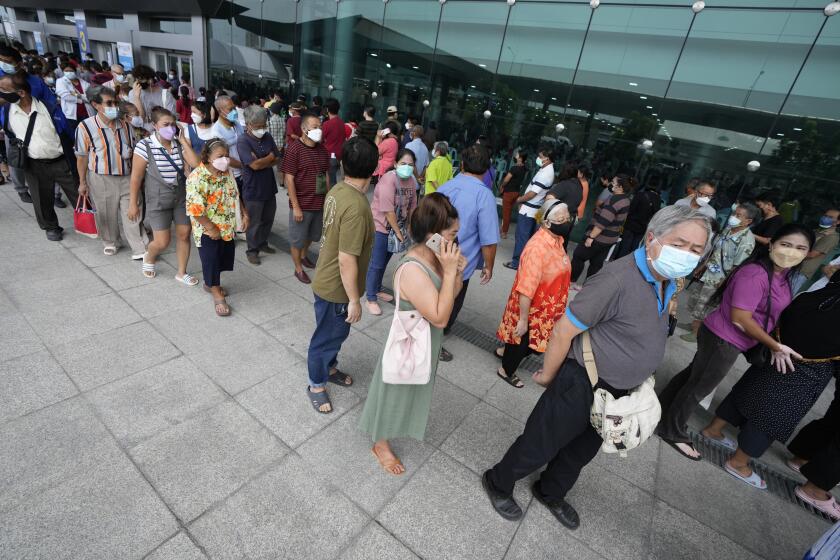 Residents wait on line to receive shots of the AstraZeneca COVID-19 vaccine at the Central Vaccination Center in Bangkok, Thailand, Thursday, July 22, 2021. (AP Photo/Sakchai Lalit)