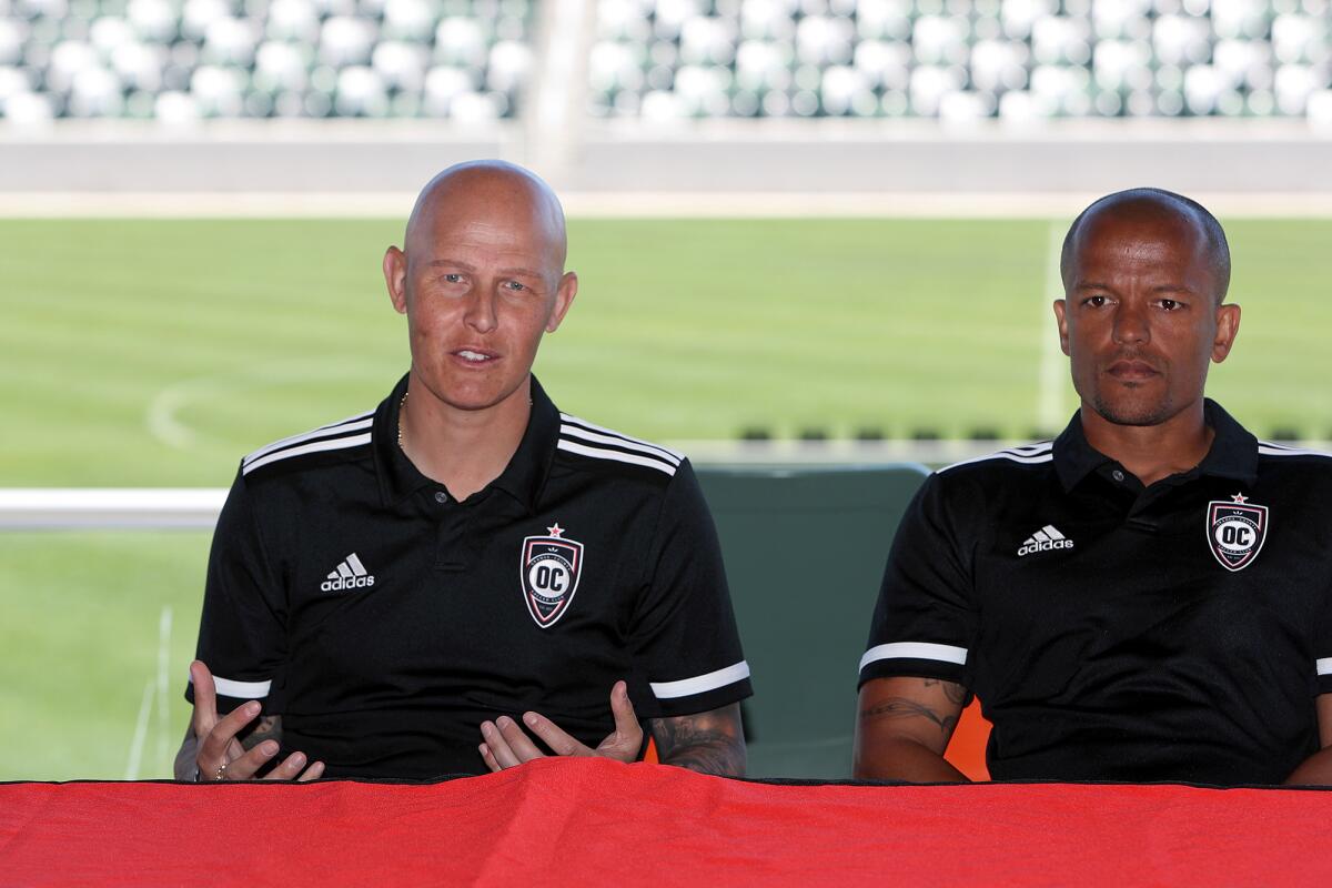 Head coach Richard Chaplow, left, and assistant coach Robert Earnshaw speak during Wednesday's media day.