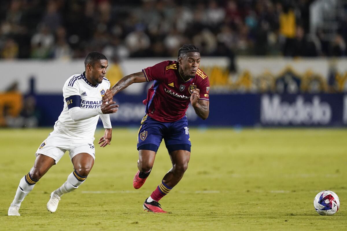 Galaxy forward Douglas Costa, left, and Real Salt Lake midfielder Nelson Palacio chase the ball.