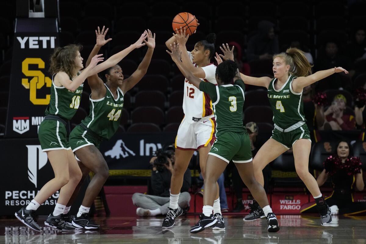USC guard JuJu Watkins is surrounded by Le Moyne players during the Trojans' 93-42 victory Monday at Galen Center.