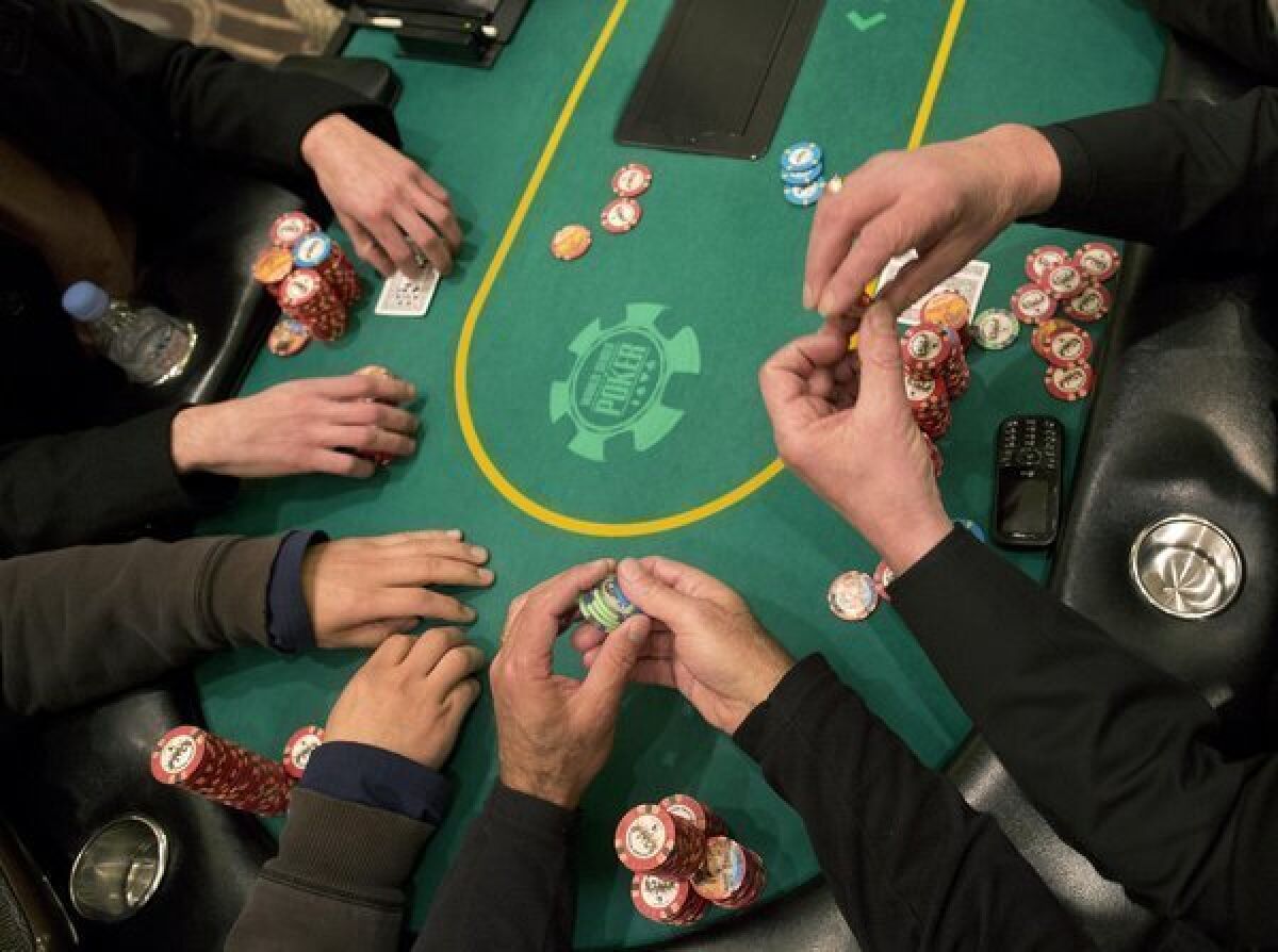 Poker players cast their bets during a hand of Texas Hold 'em at Caesar's Palace in Las Vegas.