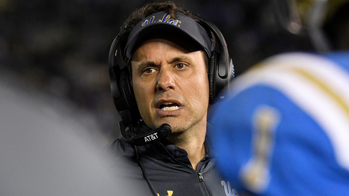 UCLA interim coach Jedd Fisch talks to his players during a game against California on Nov. 24.