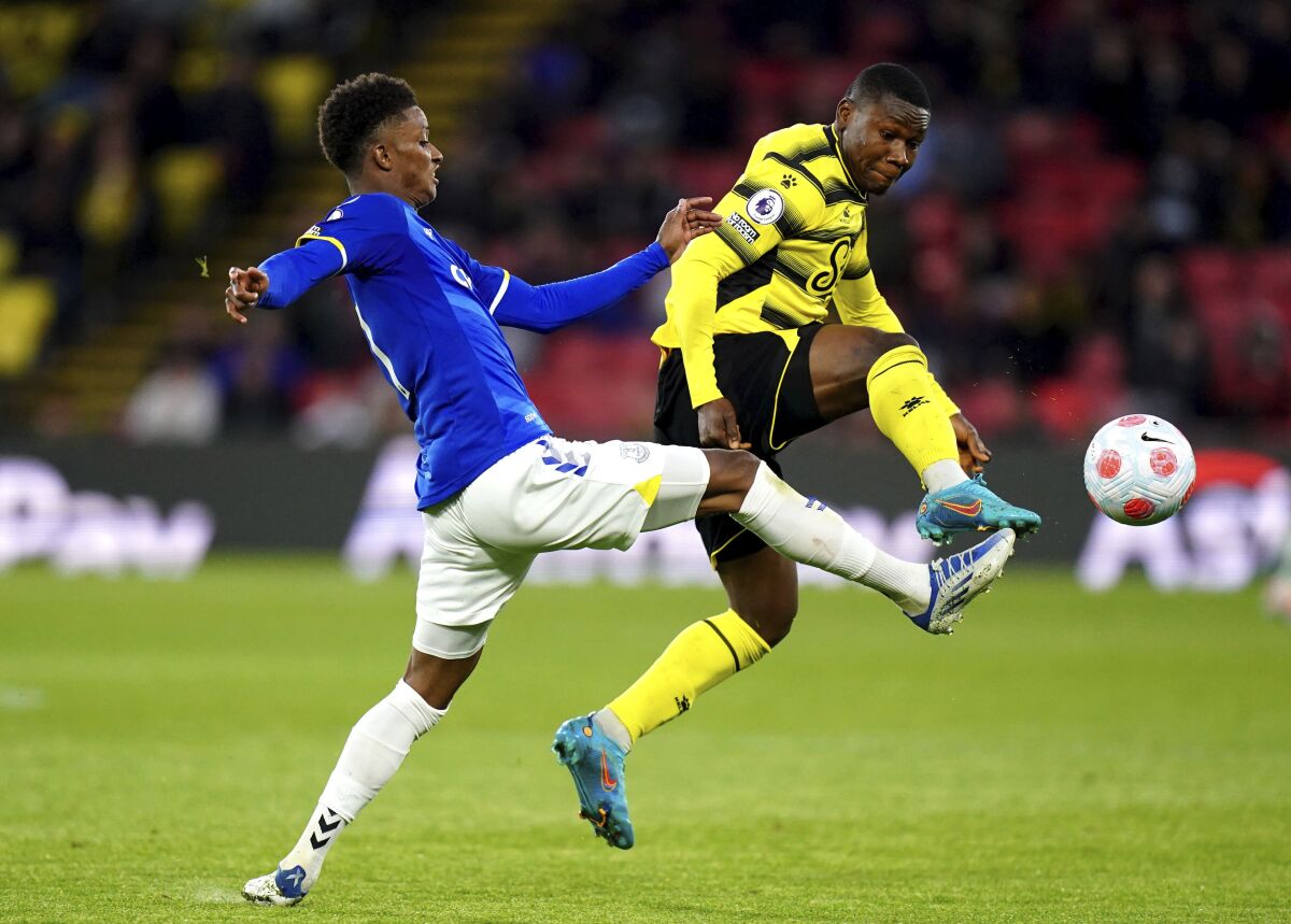 Everton's Demarai Gray (left) and Watford's Samuel Kalu battle for the ball , during the English Premier League soccer match between Watford and Everton at Vicarage Road, Watford, England, Wednesday May 11, 2022. (Adam Davy/PA via AP)