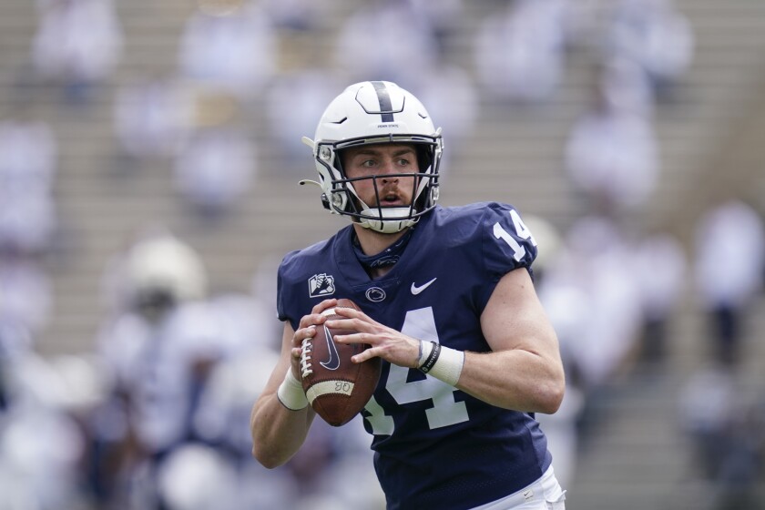 FILE - Penn State quarterback Sean Clifford (14) looks to pass during a drill at NCAA college football practice in State College, Pa., in this Saturday, April 17, 2021, file photo. Clifford has spent the better part of five preseasons learning new offenses. Although Penn State’s quarterback is taking cues from his third offensive coordinator in as many years, and fourth since he arrived on campus, Clifford has plenty of reasons to be hopeful. “I expect a lot of points,” Clifford said. (AP Photo/Keith Srakocic, File)