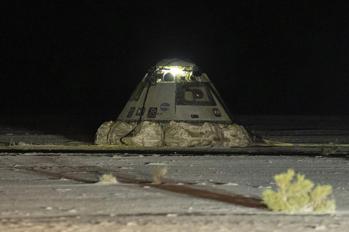 The empty Boeing Starliner capsule sits at White Sands Missile Range in New Mexico at night.