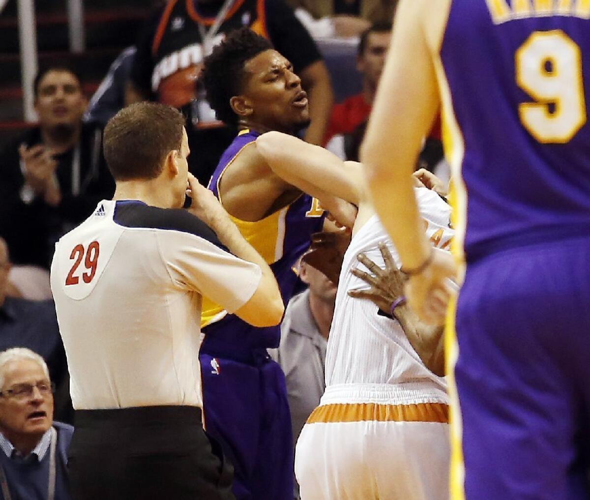 The Lakers' Nick Young throws a punch at Phoenix Suns guard Goran Dragic.
