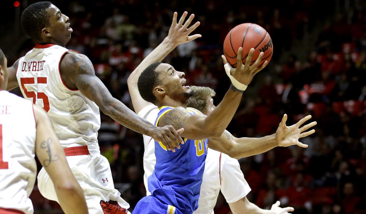 UCLA guard Norman Powell goes to the basket against Utah defenders during their 71-39 loss on Sunday.