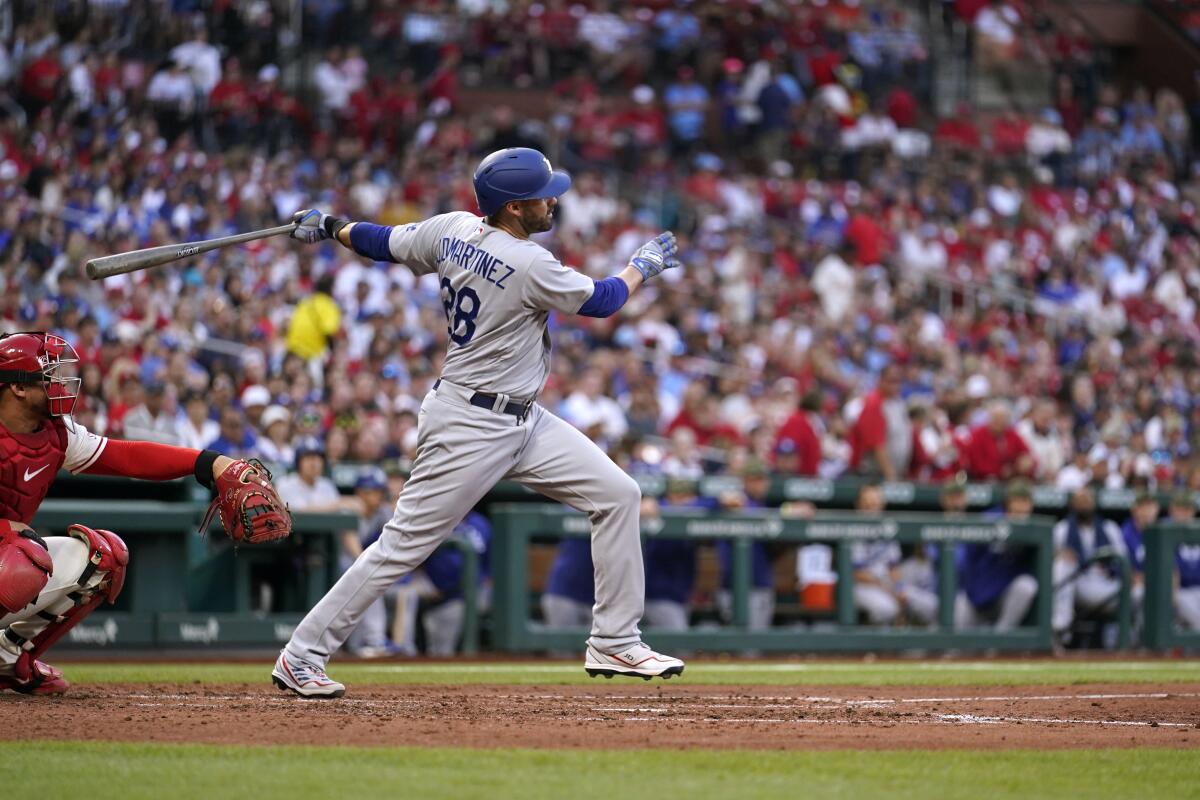 The Dodgers' J.D. Martinez connects on a three-run home run during the sixth inning to tie the score.