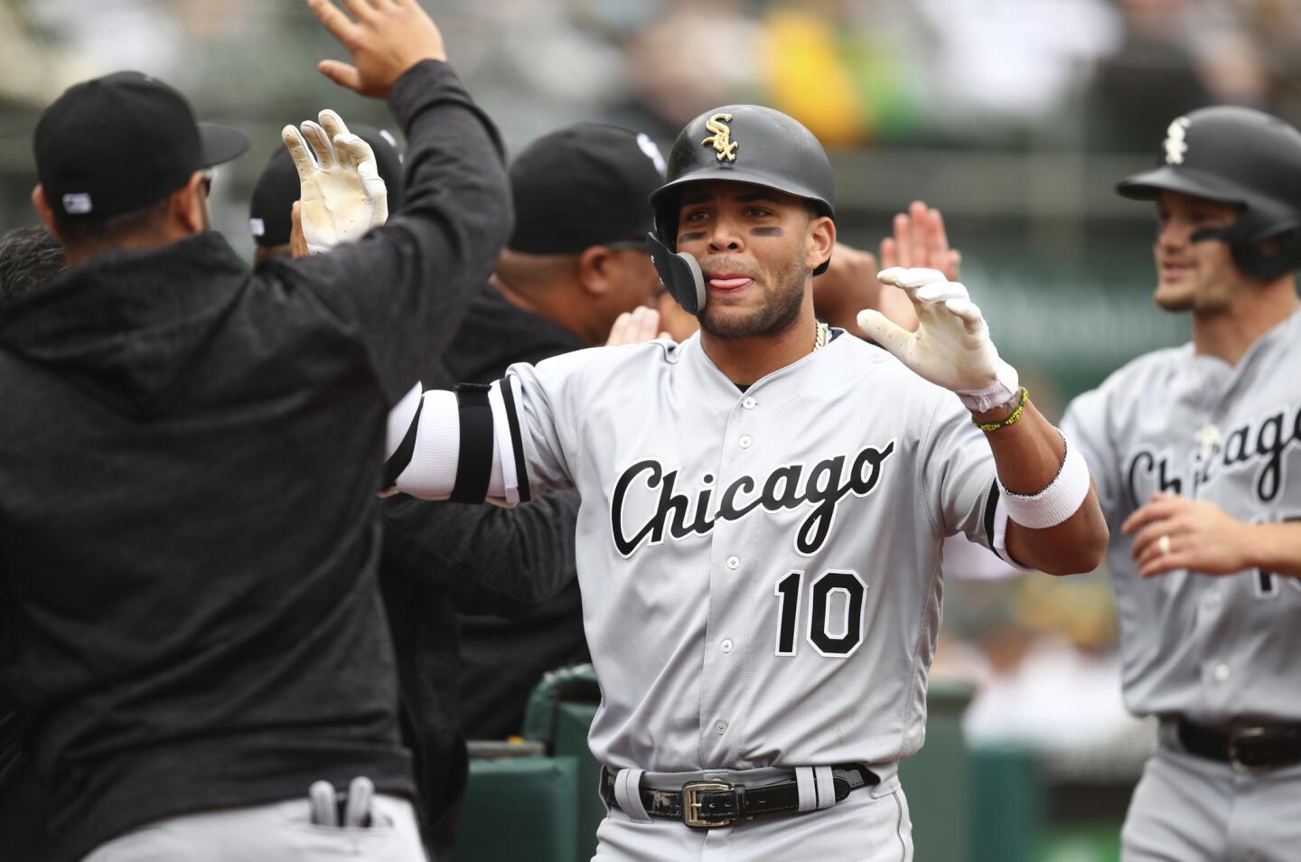 White Sox second baseman Yoan Moncada (10) celebrates after hitting a grand slam off Athletics pitcher Andrew Triggs during the second inning Wednesday, April 18, 2018, in Oakland, Calif.