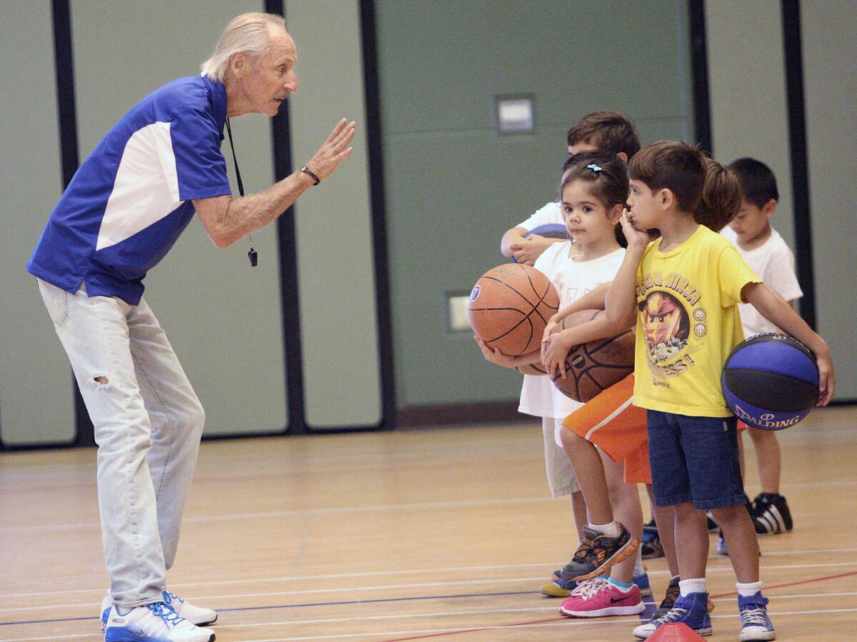Tony Passarella talks to participants during the annual basketball camp on Thursday, July 31, 2014.