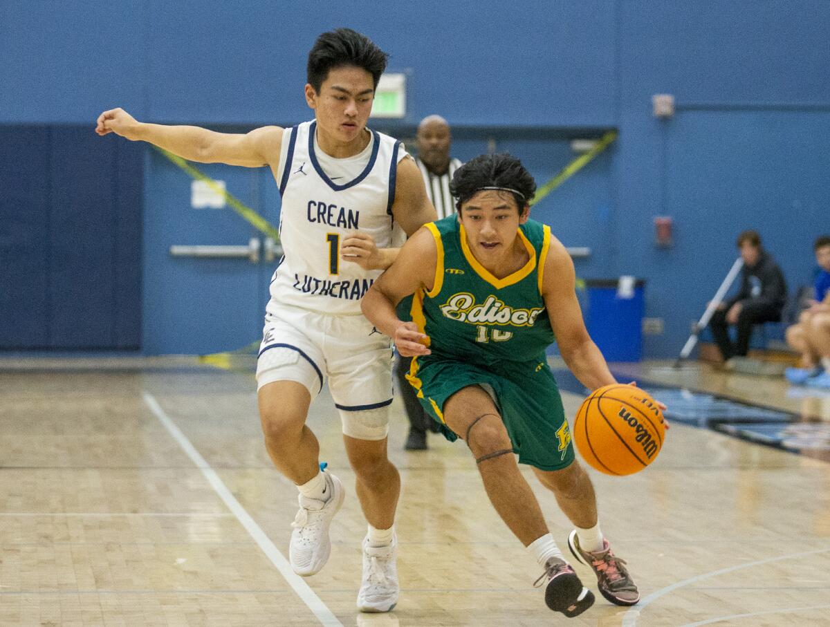 Edison's Garin Takushi drives to the hoop against Crean Lutheran's Patrick Miranda during the Corona del Mar Beach Bash.