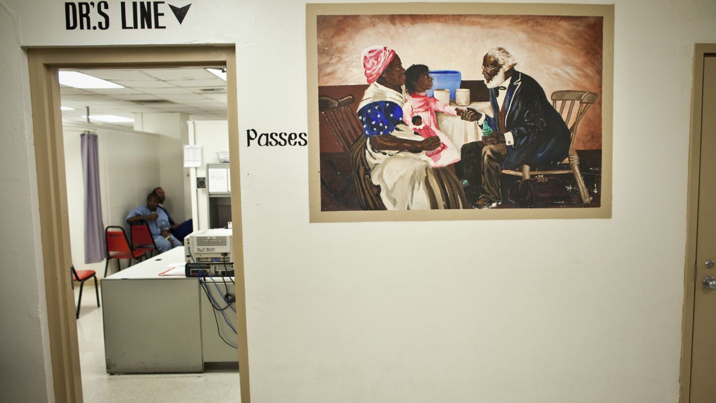 A reproduction of a painting hangs on the wall outside the medial clinic at Men's Central.