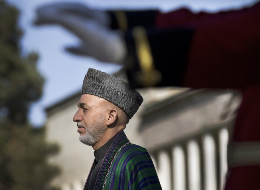 Afghan President Hamid Karzai, shown in an October photo, has asked a special commission investigating the death of a woman volunteering with a vaccination program to report to him within four days.