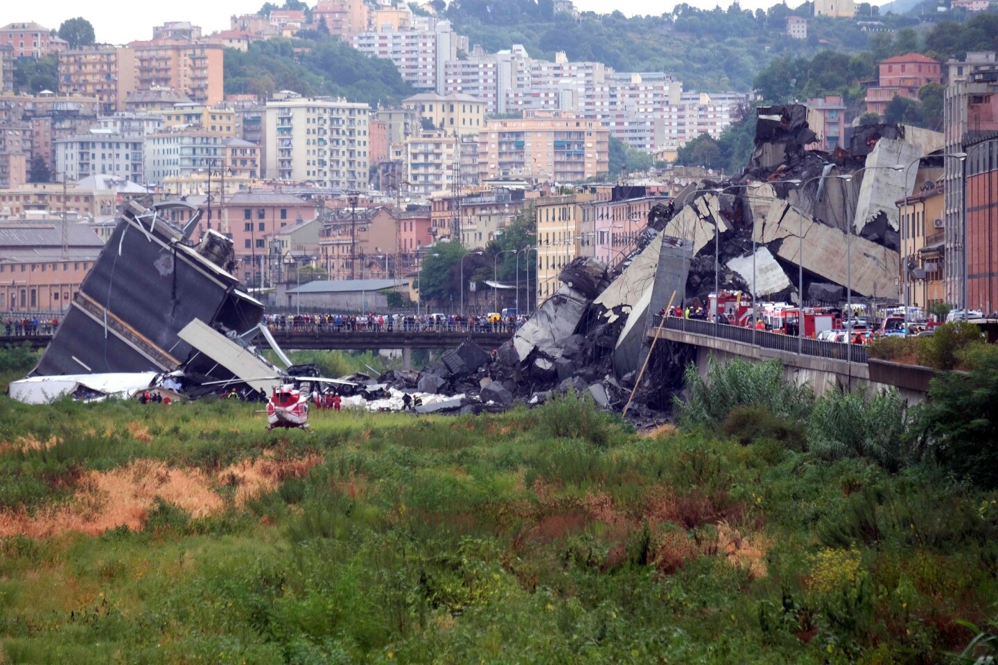 Rescuers scouring through the wreckage after part of a viaduct of the A10 freeway collapsed in Genoa, Italy.