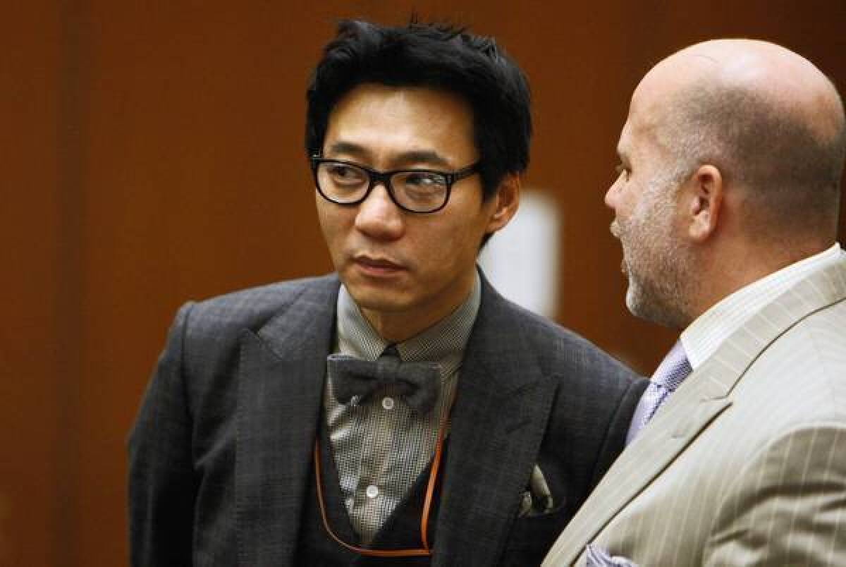 Young Lee, left, one of the founders of the Pinkberry yogurt empire, with his attorney Philip Kent Cohen during his arraignment in 2012. The defense argued that another man beat the victim with a tire iron.