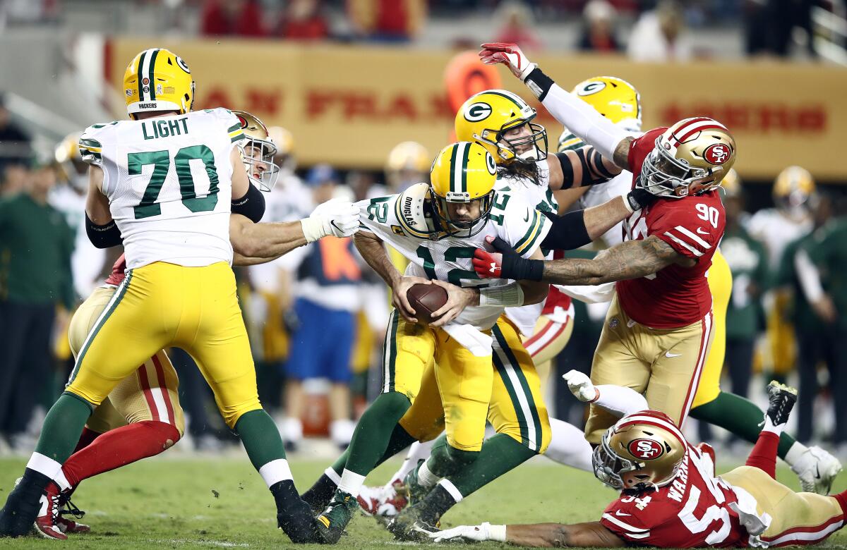 Green Bay quarterback Aaron Rodgers is pressured by San Francisco's defense during the 49ers' 37-8 victory Nov. 24, 2019.