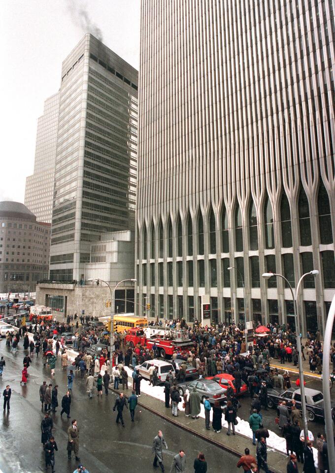 Firefighters and rescue crews work outside the World Trade Center in New York on Feb. 26, 1993, after smoke swept through the 110-story building. A bombing had brought down the ceiling of a train station and set off a fire below the twin towers.