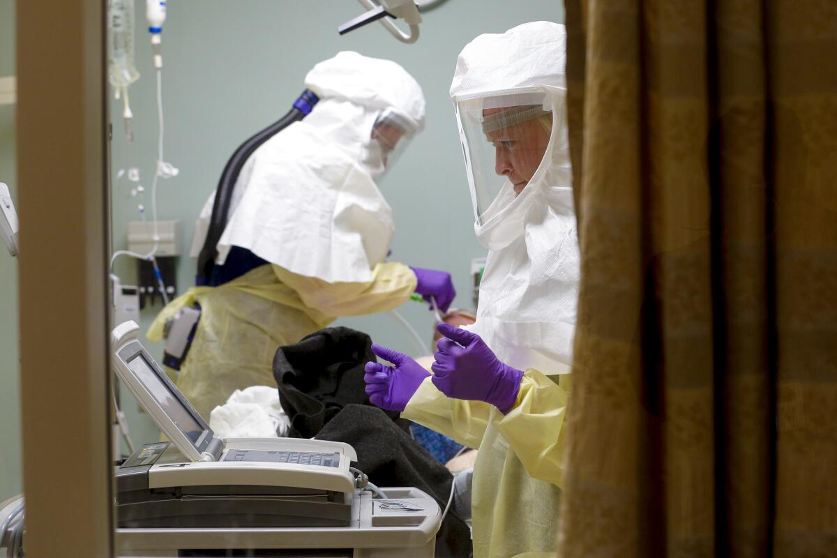At Sharp Memorial Hospital in Serra Mesa, Calif., nurses treat a patient diagnosed with Coronavirus in a special negative pressure isolation room of the Emergency Department.