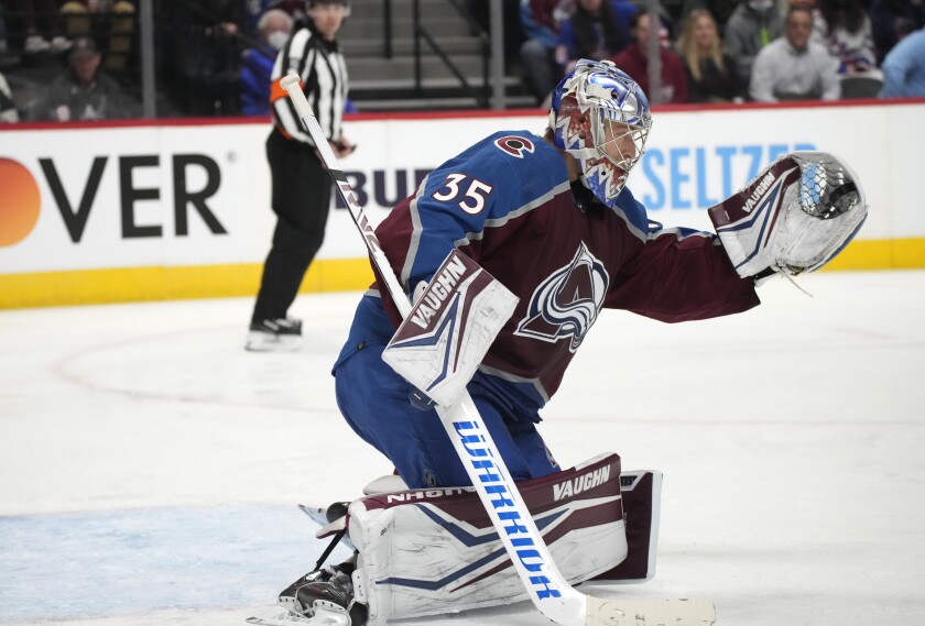 Colorado Avalanche goaltender Darcy Kuemper makes a glove save off a shot from the New York Rangers in the second period of an NHL hockey game Tuesday, Dec. 14, 2021, in Denver. (AP Photo/David Zalubowski)