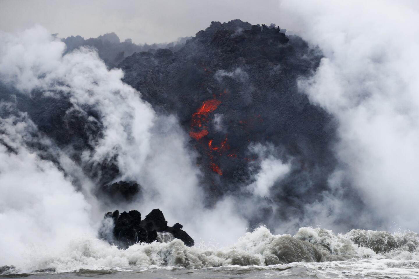 In this May 20, 2018 photo, lava flows into the ocean near Pahoa, Hawaii.