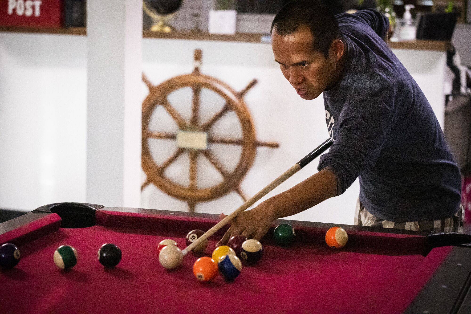 Rudy Cesar, of Lancaster, plays pool at the International Seafarers Center 