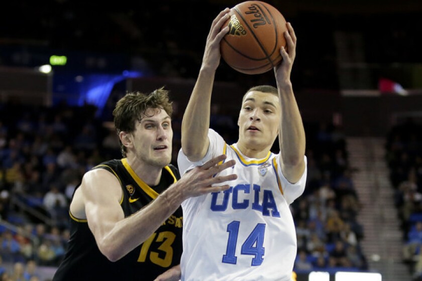 UCLA guard Zach LaVine, right, drives to the basket around Arizona State center Jordan Bachynski during the second half of the Bruins' 87-72 win Sunday at Pauley Pavilion.