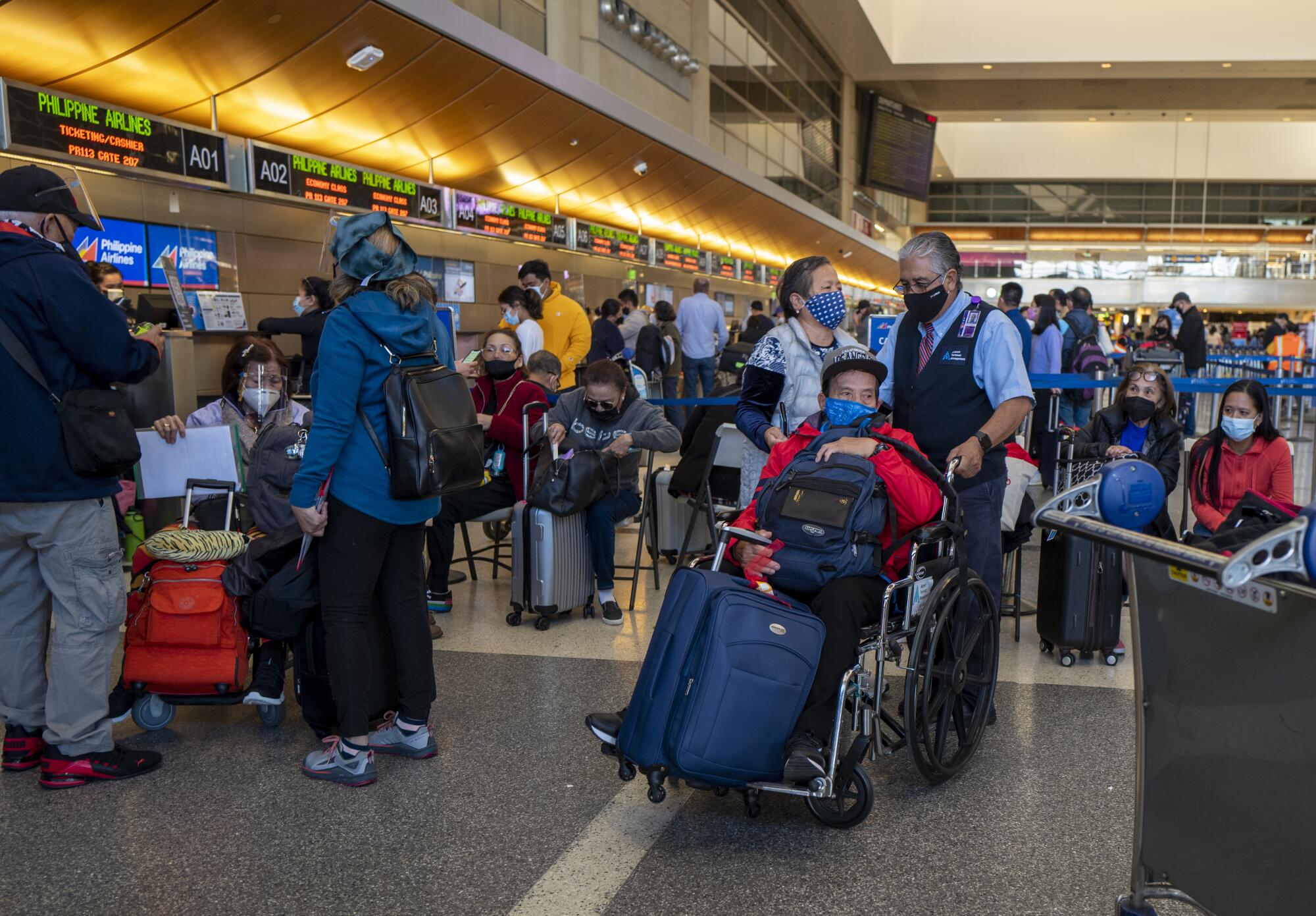 Travelers at a crowded Tom Bradley International Terminal 