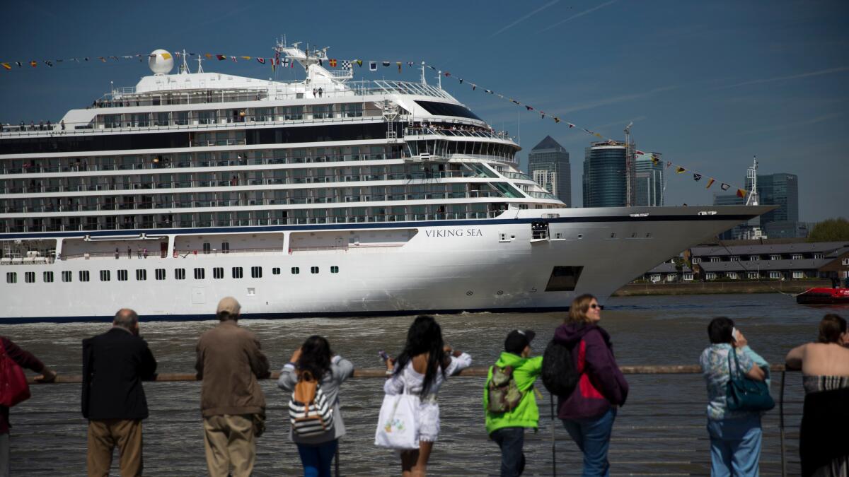 People watch as the Viking Sea cruise ship docks at Greenwich in London.