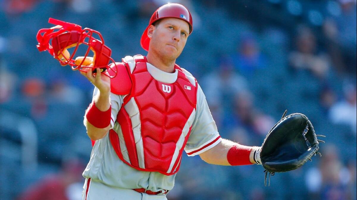 Former Dodgers catcher A.J. Ellis plays in the red of the Philadelphia Phillies after the Dodgers traded him away in August. The Times' Pedro Moura and Andy McCullough discuss the the value of Ellis, who was a favorite of Dodgers teammates and fans.