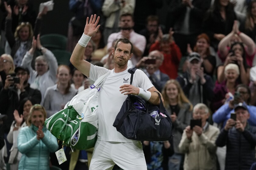 Britain's Andy Murray waves after losing the singles tennis match against John Isner of the US on day three of the Wimbledon tennis championships in London, Wednesday, June 29, 2022. (AP Photo/Alastair Grant)