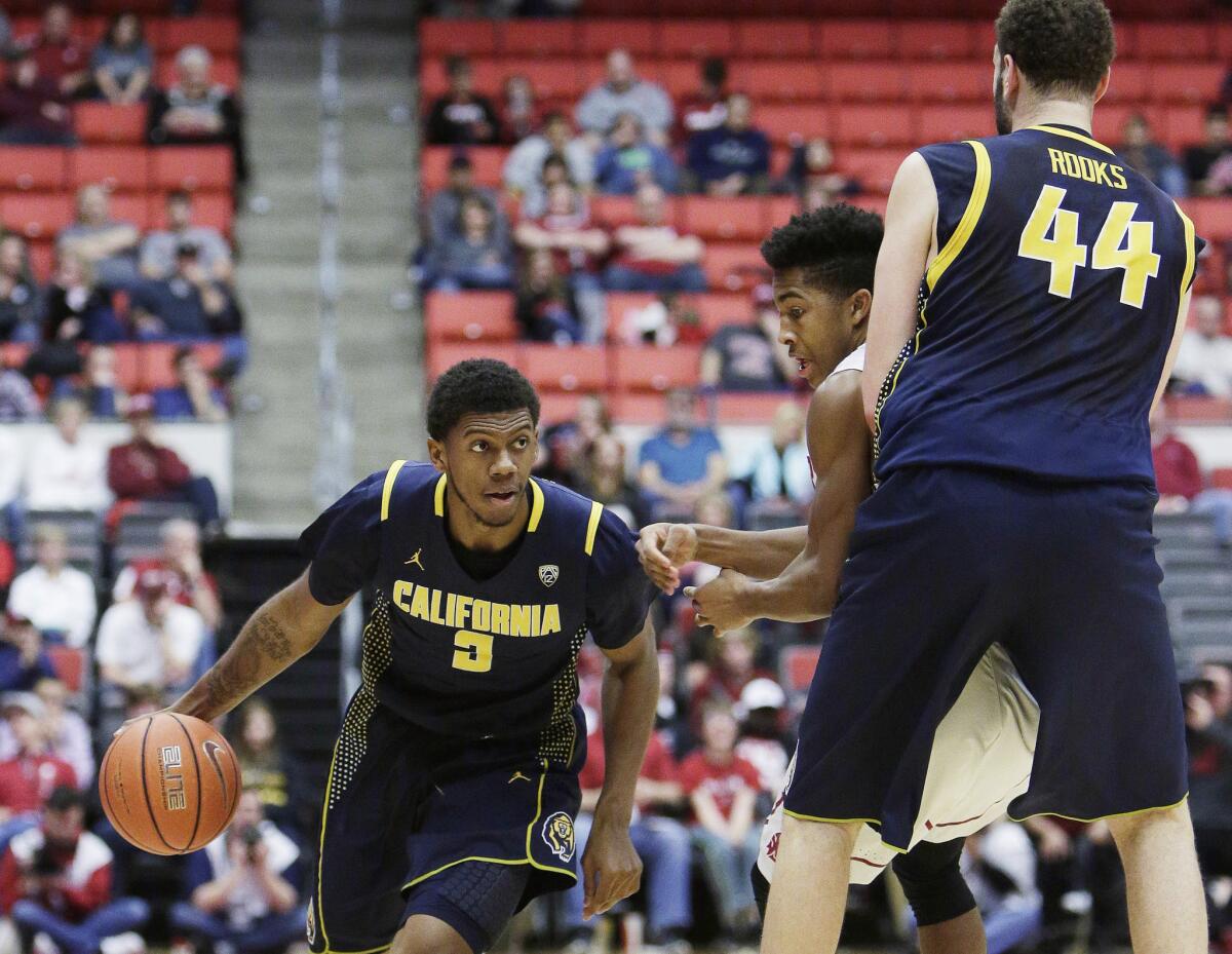 California guard Tyrone Wallace (3) drives around Washington State's Ny Redding, center, as teammate Kameron Rooks (44) provides a screen during the second half.