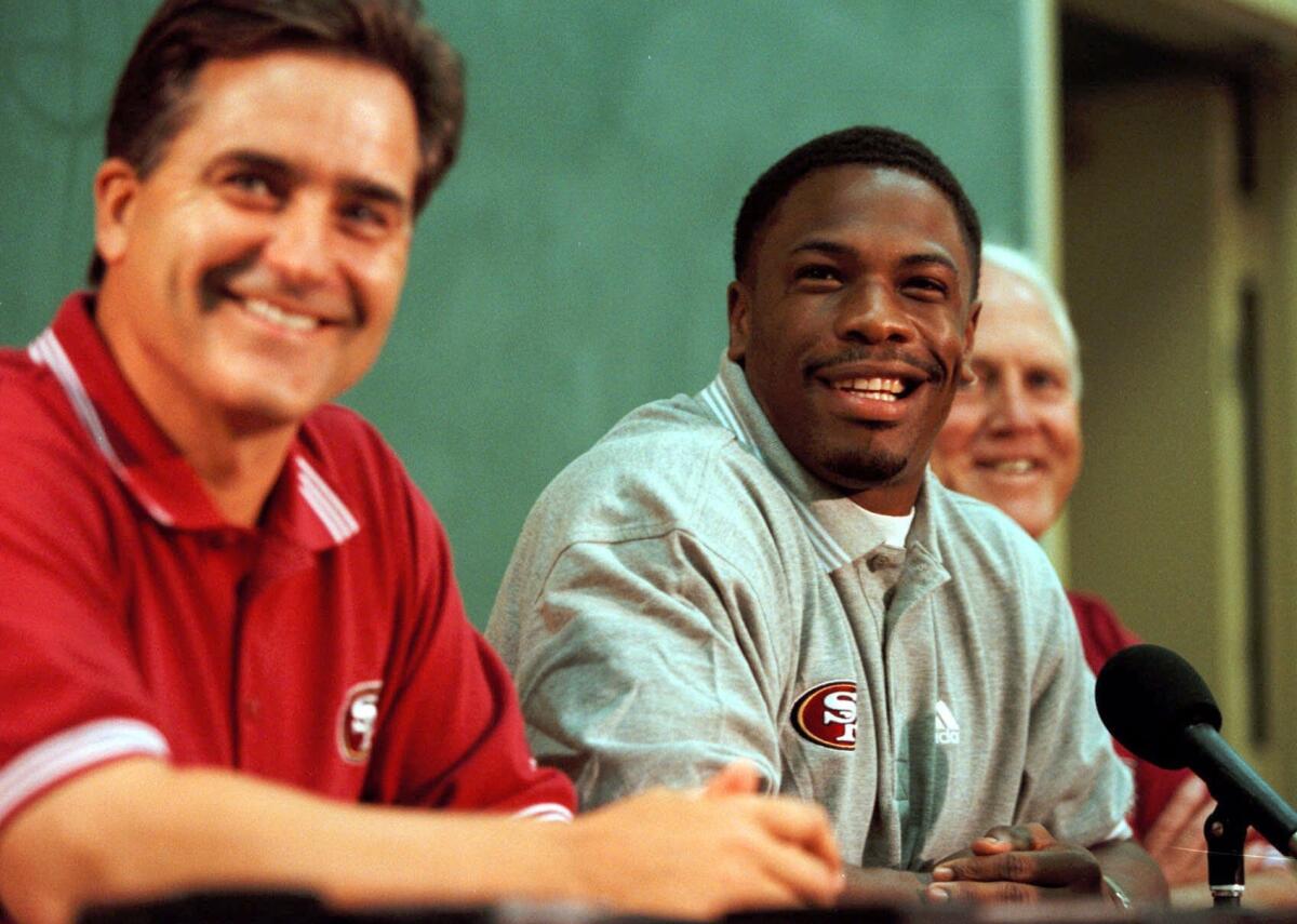 Lawrence Phillips, center, attends a news conference with the San Francisco 49ers in 1999.