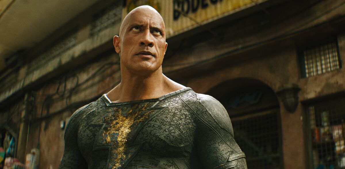 A bald man in a gray superhero costume.