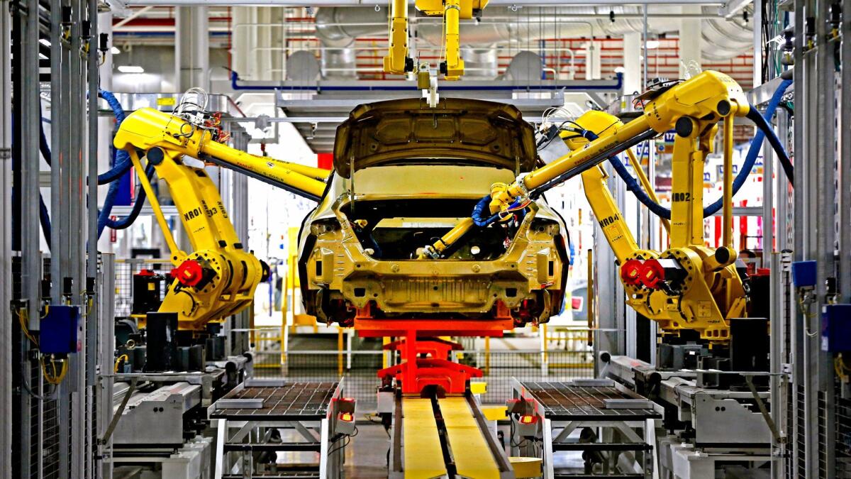 Automated robots build a car at the Sterling Heights Assembly Plant in Sterling Heights, Mich., in 2014.