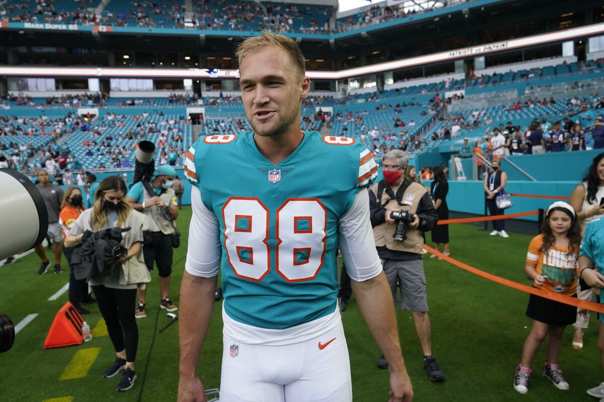 FILE - Miami Dolphins tight end Mike Gesicki (88) walks on the field ahead of an NFL football game against the New England Patriots, Sunday, Jan. 9, 2022, in Miami Gardens, Fla. The Miami Dolphins placed the franchise tag on tight end Mike Gesicki on Tuesday, March 8, which will keep him under contract for the 2022 season. (AP Photo/Willfredo Lee, File)