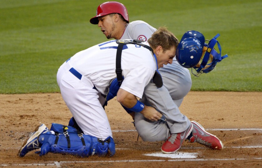 Cardinals center fielder Jon Jay collides with Dodgers catcher A.J. Ellis while scoring on a double by teammate David Freese in the second inning Friday night.